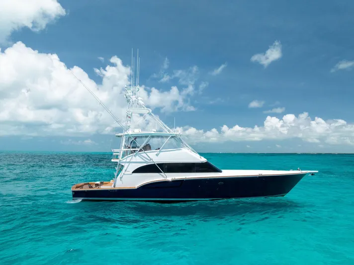 Diggin Donzi Yacht Photos Pics 2007 Donzi 73 Sportfish yacht on clear turquoise water under a bright blue sky.