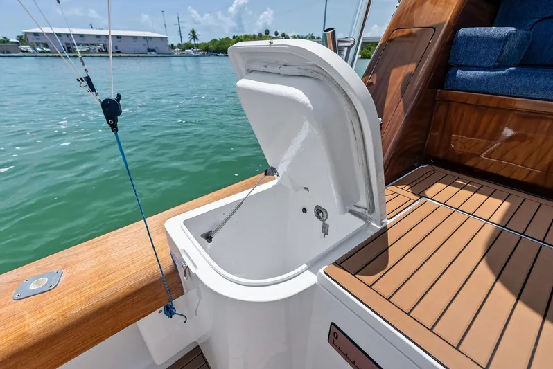 Diggin Donzi Yacht Photos Pics Open storage compartment on 2007 Donzi 73 Sportfish boat deck, near water.