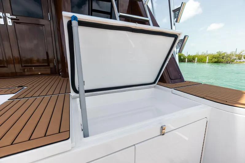 Diggin Donzi Yacht Photos Pics Open storage compartment on 2007 Donzi 73 Sportfish boat, featuring teak deck and ocean view.