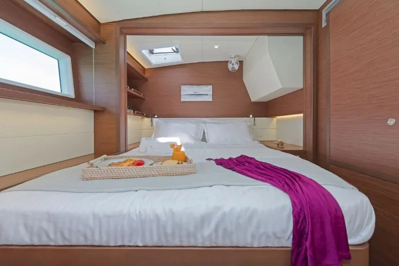 Lagoon 52f Yacht Photos Pics Luxurious cabin interior of 2019 Lagoon 52F yacht with cozy bed and breakfast tray.