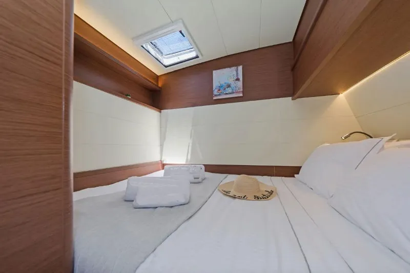 Lagoon 52f Yacht Photos Pics Luxurious cabin interior of 2019 Lagoon 52F yacht with cozy bedding and natural light.