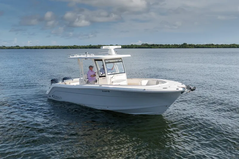 Hi Ho Silver Yacht Photos Pics 2022 Robalo R302 Center Console boat cruising on calm waters under a cloudy sky.