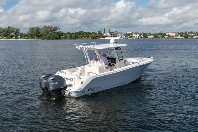 Hi Ho Silver Yacht Photos Pics 2022 Robalo R302 Center Console boat on calm water with twin Yamaha engines.