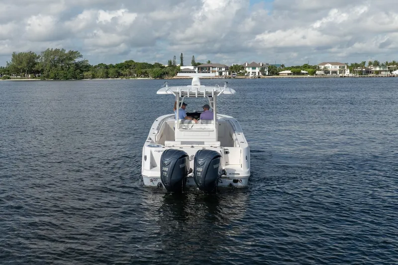 Hi Ho Silver Yacht Photos Pics 2022 Robalo R302 Center Console boat cruising on a calm lake.