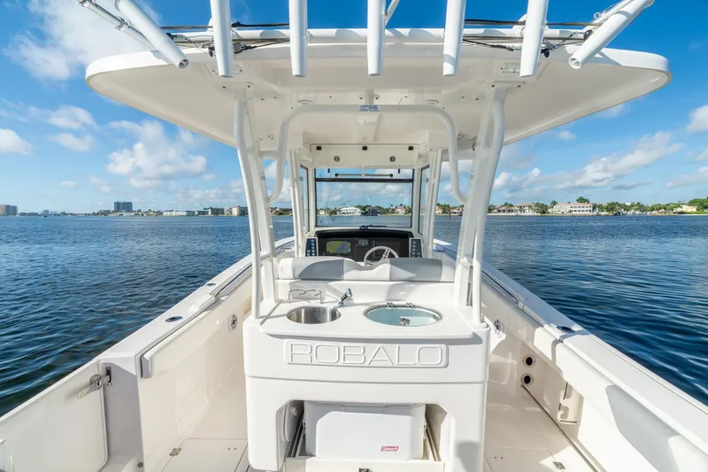 Hi Ho Silver Yacht Photos Pics 2022 Robalo R302 Center Console boat on calm water, showcasing helm and seating area.