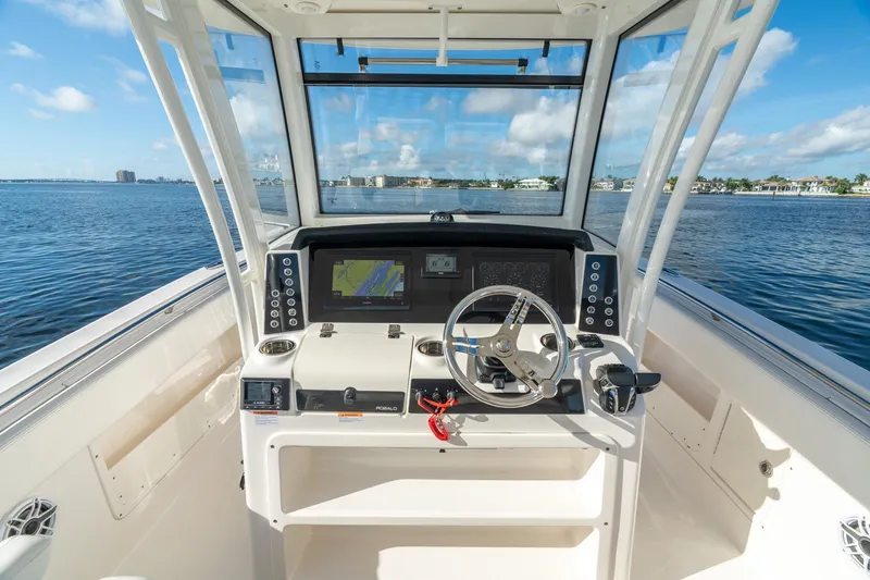 Hi Ho Silver Yacht Photos Pics 2022 Robalo R302 Center Console boat helm with navigation display on open water.