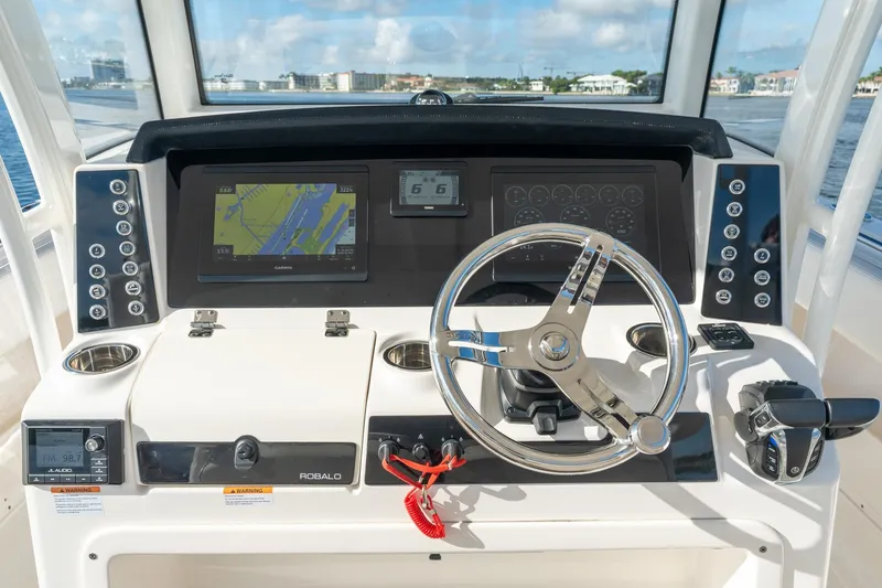 Hi Ho Silver Yacht Photos Pics 2022 Robalo R302 Center Console helm with navigation display and steering wheel.