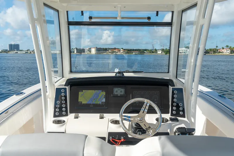 Hi Ho Silver Yacht Photos Pics 2022 Robalo R302 Center Console boat dashboard with navigation system on open water.