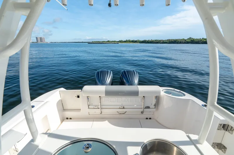 Hi Ho Silver Yacht Photos Pics 2022 Robalo R302 Center Console boat on calm water, featuring dual engines and spacious deck.