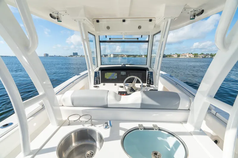 Hi Ho Silver Yacht Photos Pics 2022 Robalo R302 Center Console boat interior with steering wheel and navigation system.