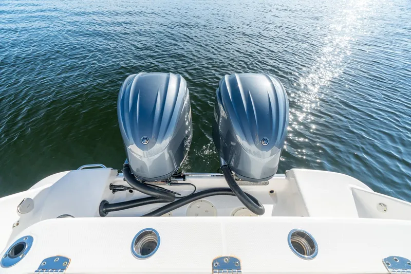 Hi Ho Silver Yacht Photos Pics 2022 Robalo R302 Center Console boat with dual outboard engines on water.