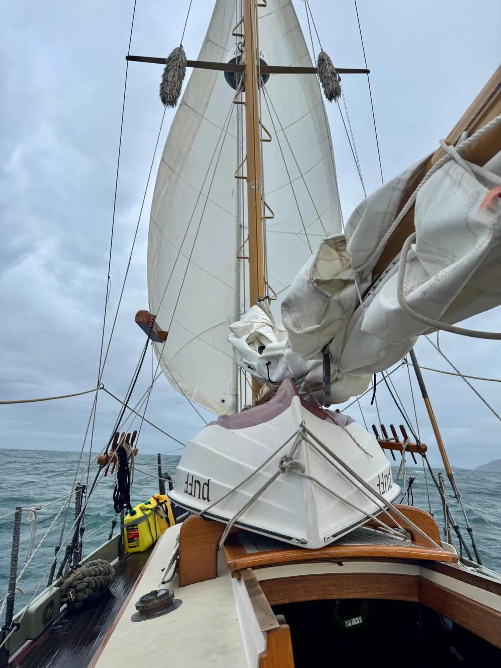 1982 Bristol Channel Cutter 28 sailing on open sea under cloudy skies.
