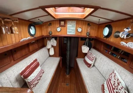 Interior of 1982 Bristol Channel Cutter 28, featuring cozy seating and nautical decor.
