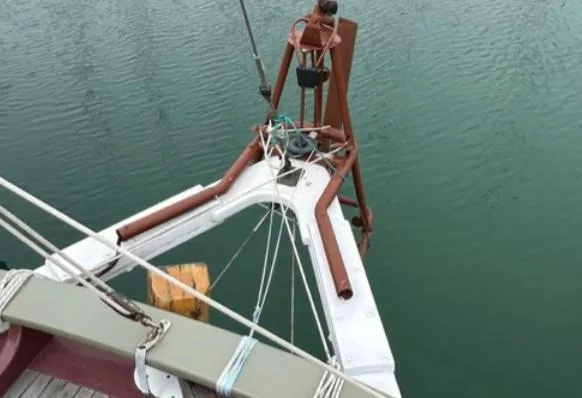 Bristol Channel Cutter 28 sailboat deck and rigging, 1982 model, on calm water.