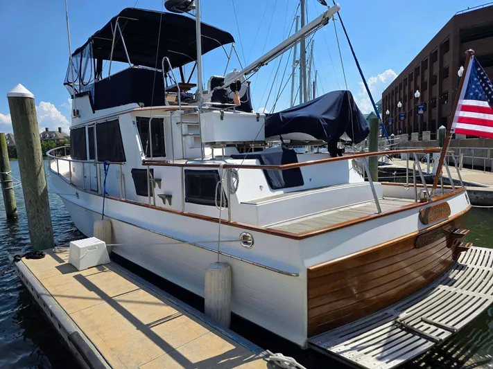 Kokomo Yacht Photos Pics 1993 Grand Banks 42 Classic yacht docked, featuring elegant wood accents and an American flag.