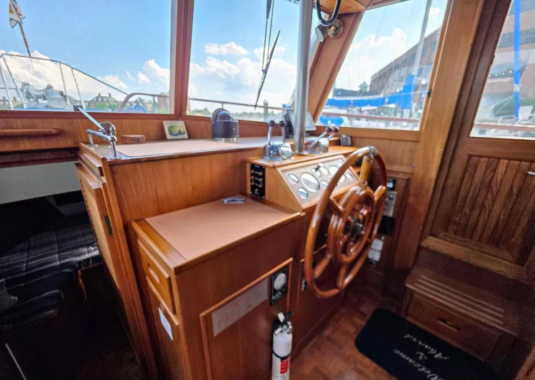 Kokomo Yacht Photos Pics Interior helm of 1993 Grand Banks 42 Classic yacht with wooden steering wheel and controls.