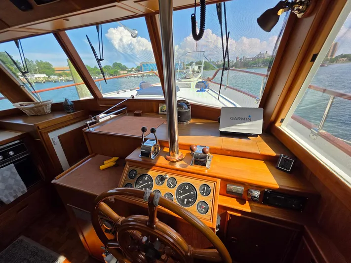 Kokomo Yacht Photos Pics Interior helm of 1993 Grand Banks 42 Classic yacht with wooden dashboard and Garmin navigation.