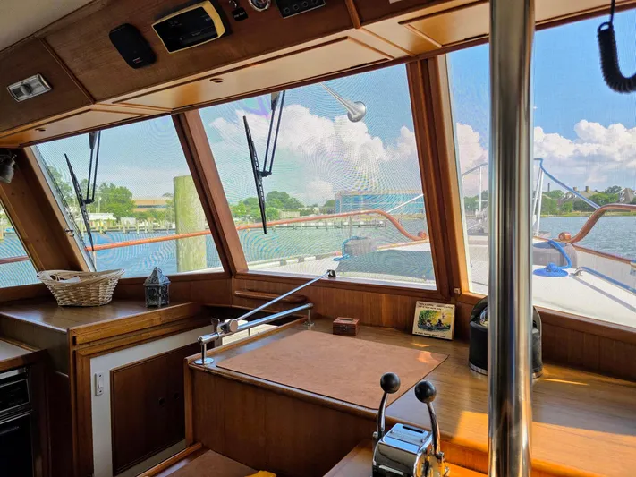 Kokomo Yacht Photos Pics Interior view of 1993 Grand Banks 42 Classic yacht with wooden finish and marina view.