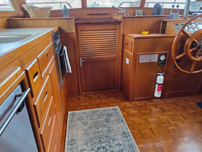 Kokomo Yacht Photos Pics Interior of 1993 Grand Banks 42 Classic yacht with wooden cabinetry and steering wheel.
