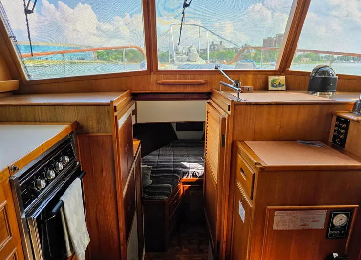 Kokomo Yacht Photos Pics 1993 Grand Banks 42 Classic interior with wood finish, bed, and kitchen area.