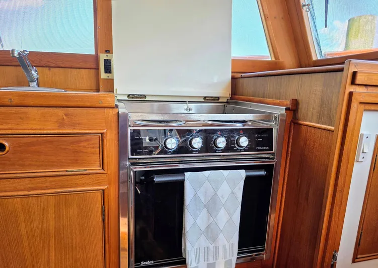 Kokomo Yacht Photos Pics 1993 Grand Banks 42 Classic yacht kitchen with stove and wooden cabinetry.
