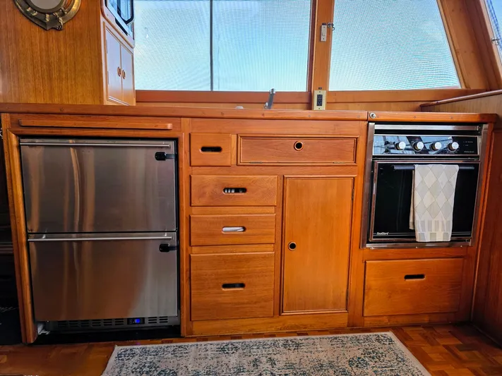 Kokomo Yacht Photos Pics Wooden kitchen interior of 1993 Grand Banks 42 Classic yacht with stainless steel appliances.