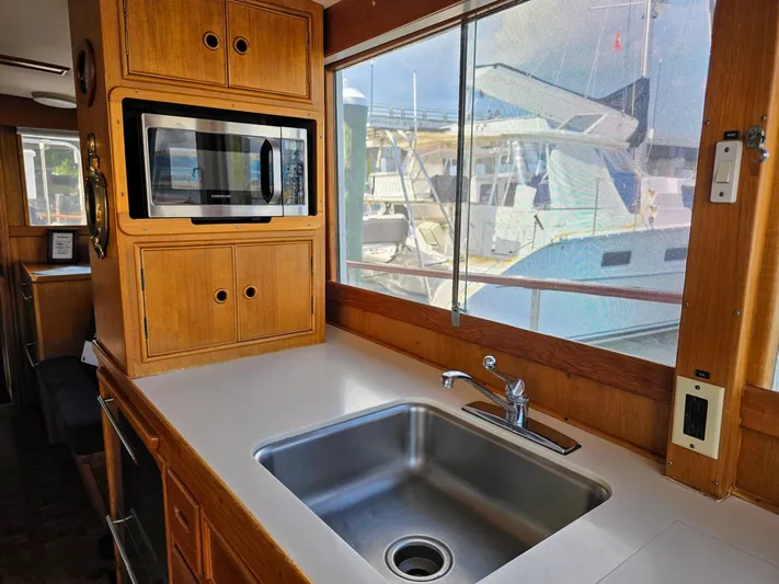 Kokomo Yacht Photos Pics Interior of 1993 Grand Banks 42 Classic yacht kitchen with sink and microwave.