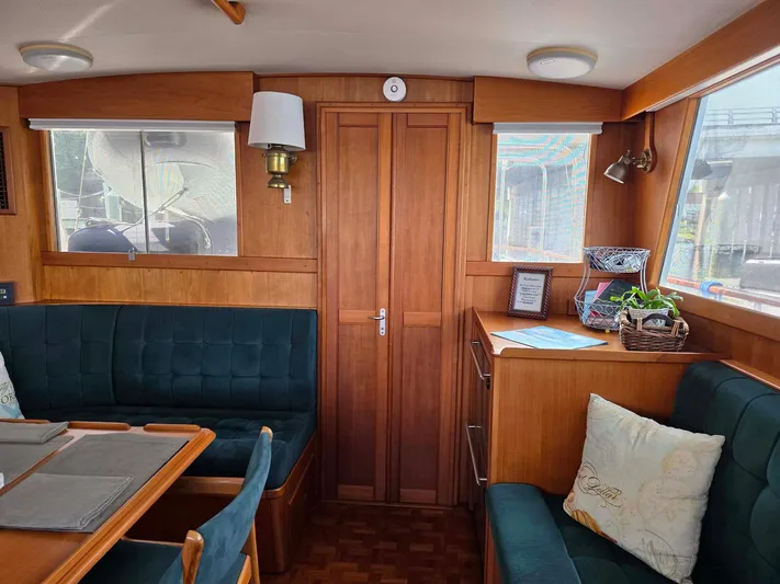 Kokomo Yacht Photos Pics Interior of 1993 Grand Banks 42 Classic yacht with wood paneling and green seating.