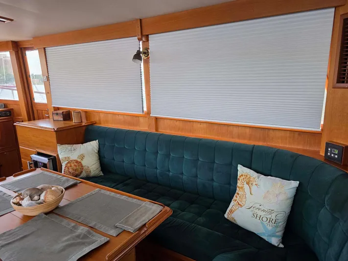 Kokomo Yacht Photos Pics Interior of 1993 Grand Banks 42 Classic yacht with teal seating and decorative pillows.