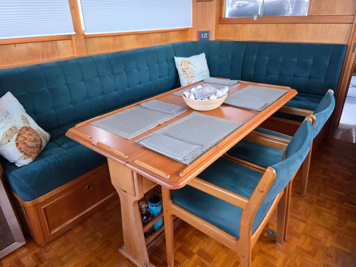 Kokomo Yacht Photos Pics Interior of 1993 Grand Banks 42 Classic yacht with elegant dining area and teal seating.