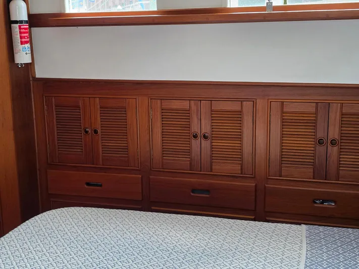 Kokomo Yacht Photos Pics Wooden interior of 1993 Grand Banks 42 Classic yacht with storage cabinets and fire extinguisher.