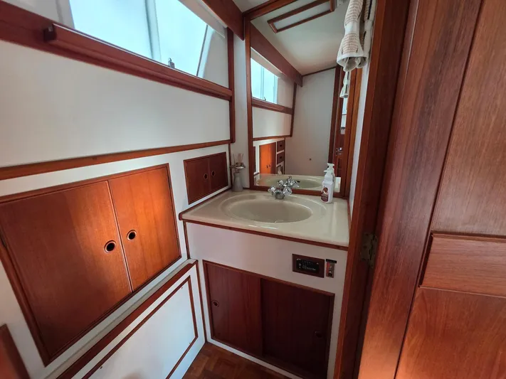 Kokomo Yacht Photos Pics Bathroom interior of 1993 Grand Banks 42 Classic yacht with wood accents and sink.