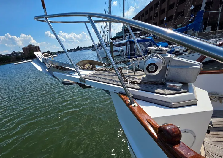 Kokomo Yacht Photos Pics Bow of 1993 Grand Banks 42 Classic yacht with anchor and winch, docked in marina.