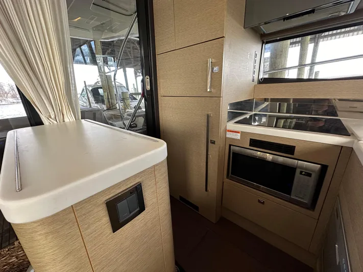  Yacht Photos Pics Modern kitchen interior of 2017 Prestige 500 yacht with sleek appliances and cabinetry.