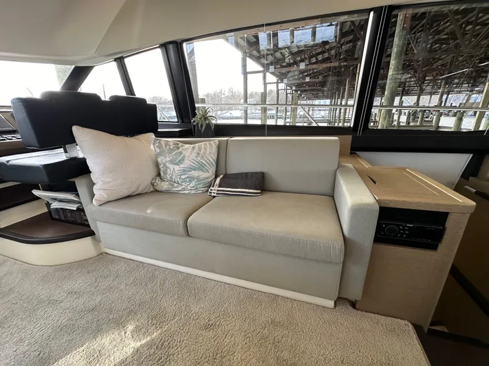  Yacht Photos Pics Luxurious interior of a 2017 Prestige 500 yacht with a comfortable sofa and scenic windows.