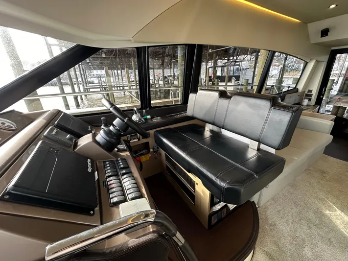  Yacht Photos Pics Interior of a 2017 Prestige 500 yacht, featuring a modern helm and seating area.