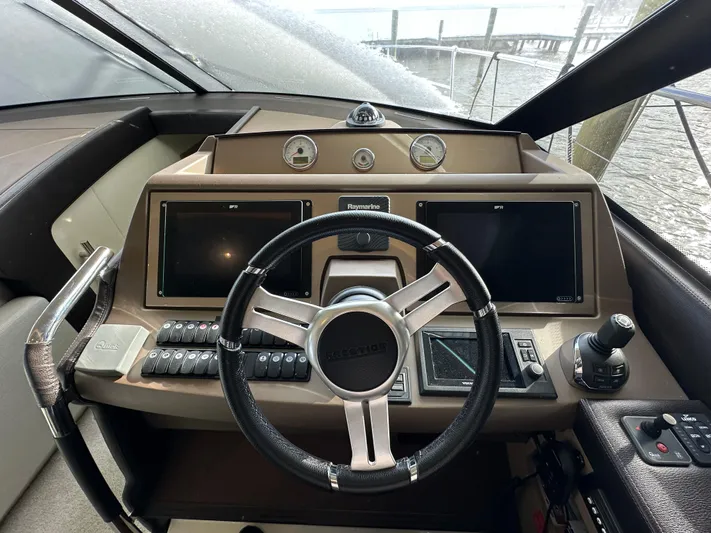  Yacht Photos Pics Steering wheel and dashboard of a 2017 Prestige 500 yacht, featuring modern navigation displays.