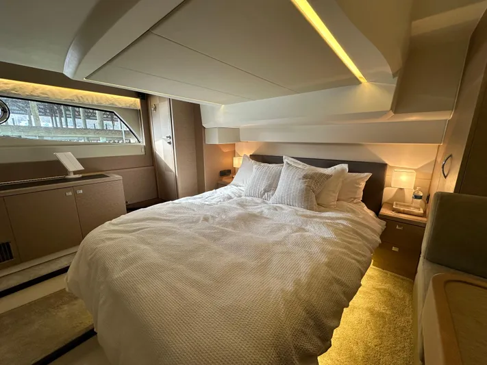  Yacht Photos Pics Luxurious bedroom interior of a 2017 Prestige 500 yacht with elegant lighting and cozy bedding.