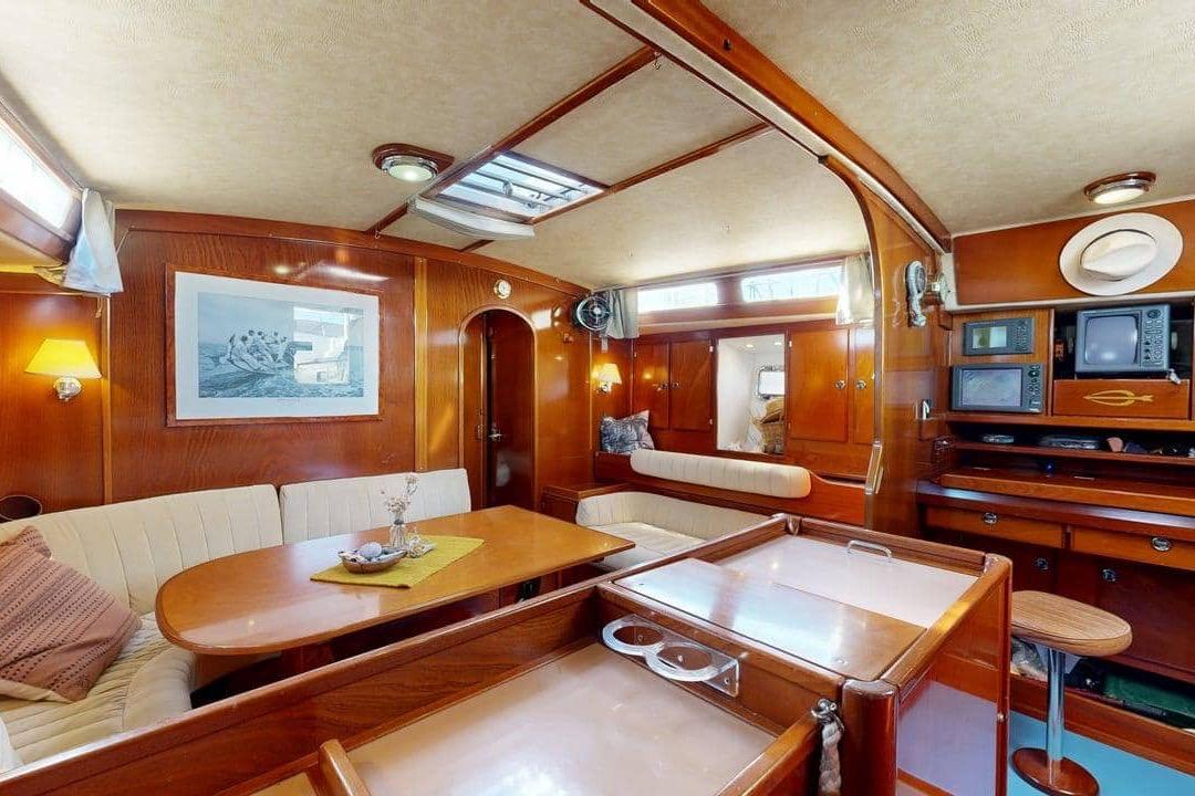 Luxurious interior of 2001 Amel Super Maramu 2000 yacht with elegant wood finish.