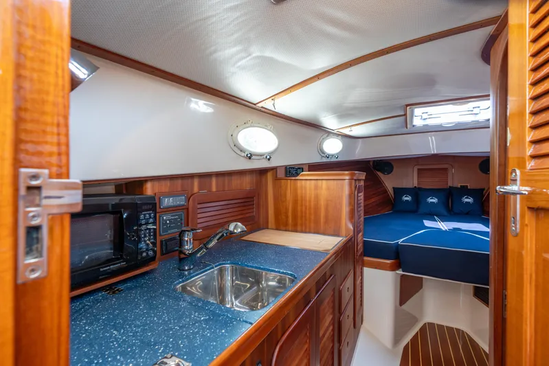 Sometimes Yacht Photos Pics Interior of 2007 Hinckley Picnic Boat EP with kitchenette and cozy sleeping area.