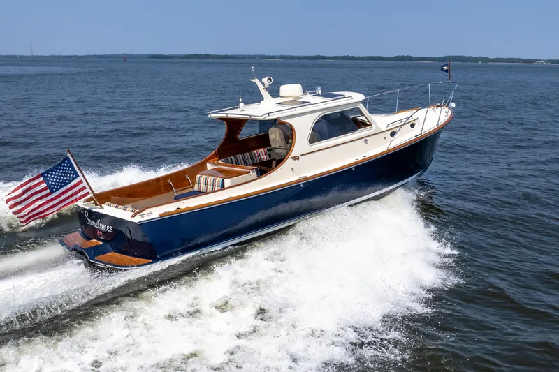 Sometimes Yacht Photos Pics 2007 Hinckley Picnic Boat EP cruising on open water with American flag.