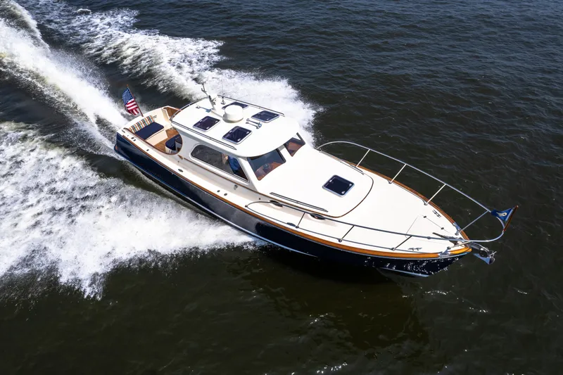 Sometimes Yacht Photos Pics 2007 Hinckley Picnic Boat EP cruising on open water, showcasing elegant design and performance.