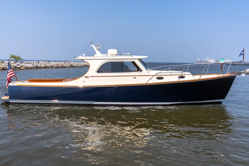 Sometimes Yacht Photos Pics 2007 Hinckley Picnic Boat EP on calm water, showcasing elegant design and craftsmanship.