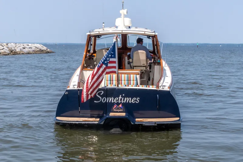 Sometimes Yacht Photos Pics 2007 Hinckley Picnic Boat EP on water, American flag, rear view.