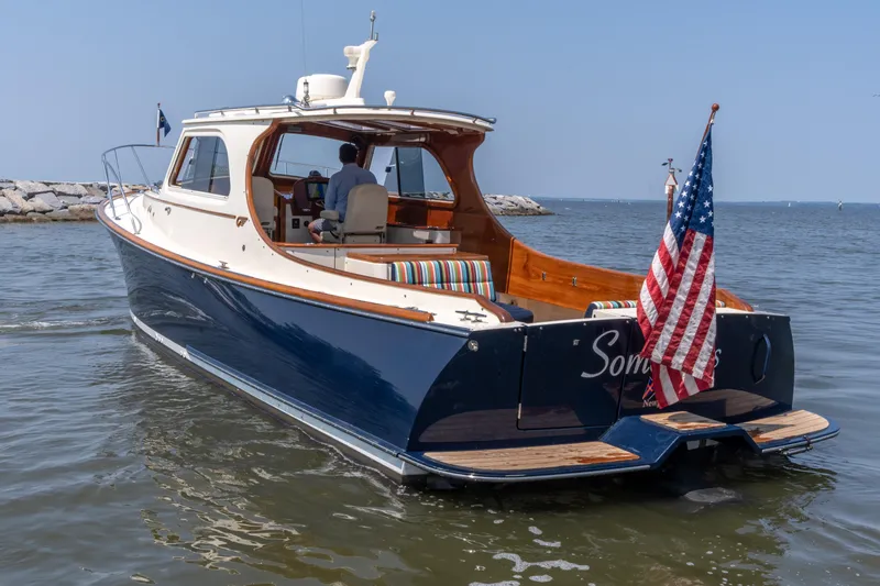 Sometimes Yacht Photos Pics 2007 Hinckley Picnic Boat EP cruising on calm waters with American flag.