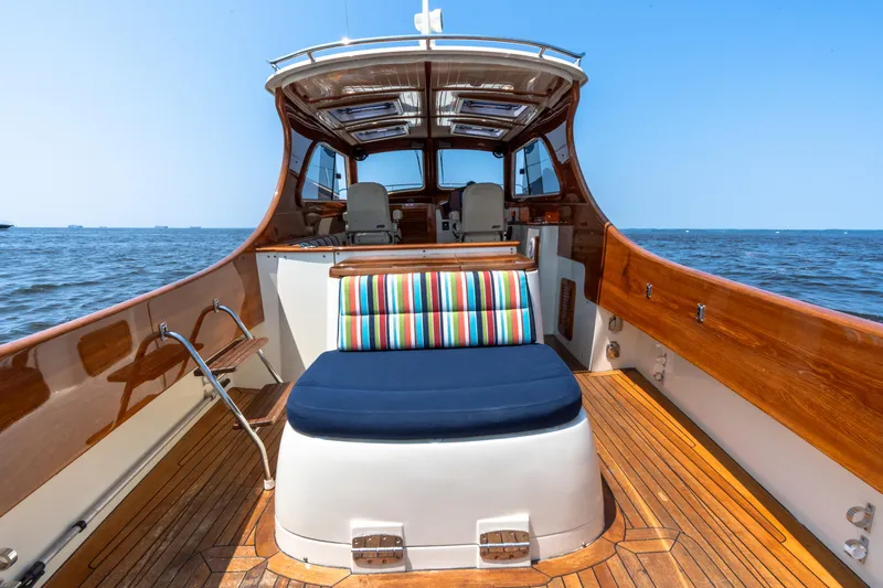 Sometimes Yacht Photos Pics 2007 Hinckley Picnic Boat EP with wooden deck and colorful seating on open water.
