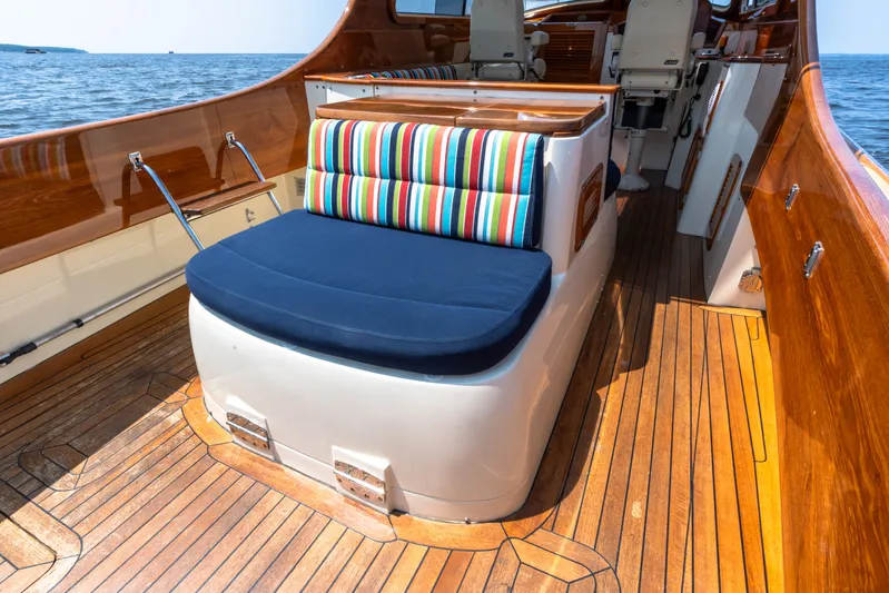 Sometimes Yacht Photos Pics 2007 Hinckley Picnic Boat EP interior with striped cushions and wooden deck.