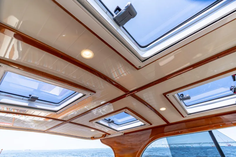 Sometimes Yacht Photos Pics Interior view of 2007 Hinckley Picnic Boat EP with skylights and wooden trim.