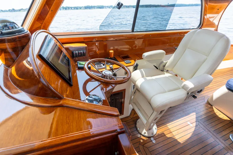 Sometimes Yacht Photos Pics Luxurious 2007 Hinckley Picnic Boat EP helm with polished wood and leather seating.