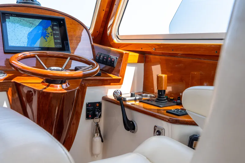 Sometimes Yacht Photos Pics 2007 Hinckley Picnic Boat EP helm with wooden steering wheel and navigation display.